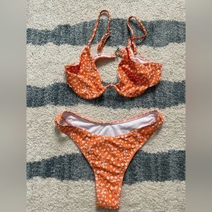 She in orange floral bathing suit